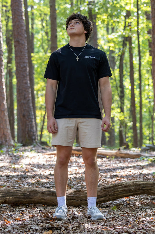 BIRD Beyond Tee in black, worn in the woods