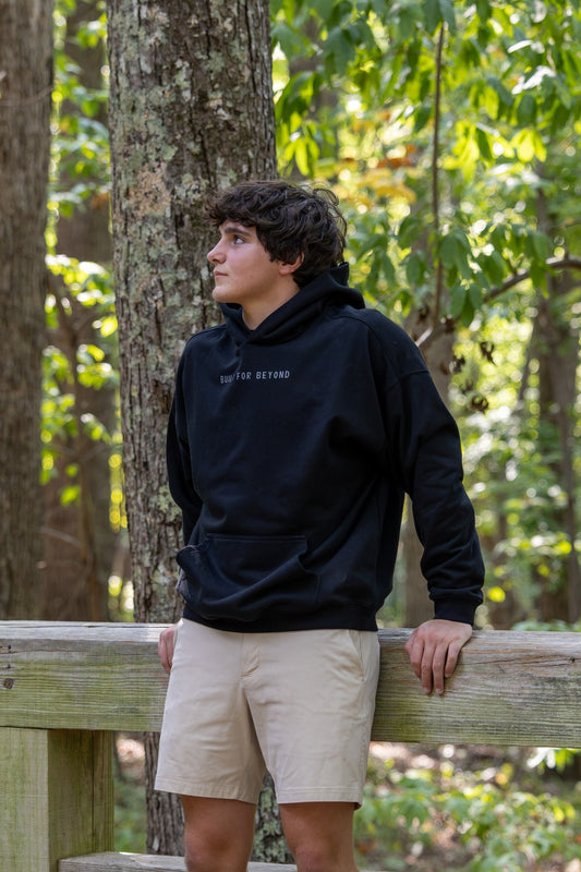 BIRD Campsite Heavyweight Hoodie in black, front view with kangaroo pocket and BUILT FOR BEYOND chest print