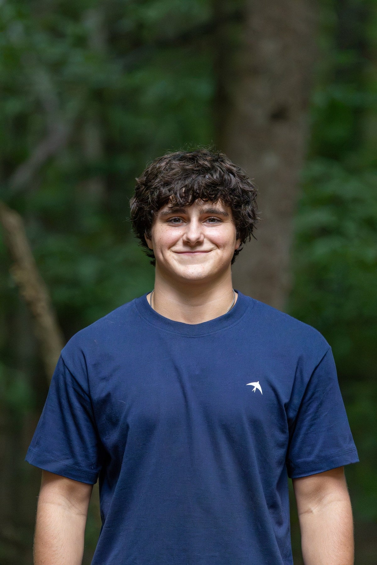 BIRD Falcon Tee in navy, worn outdoors