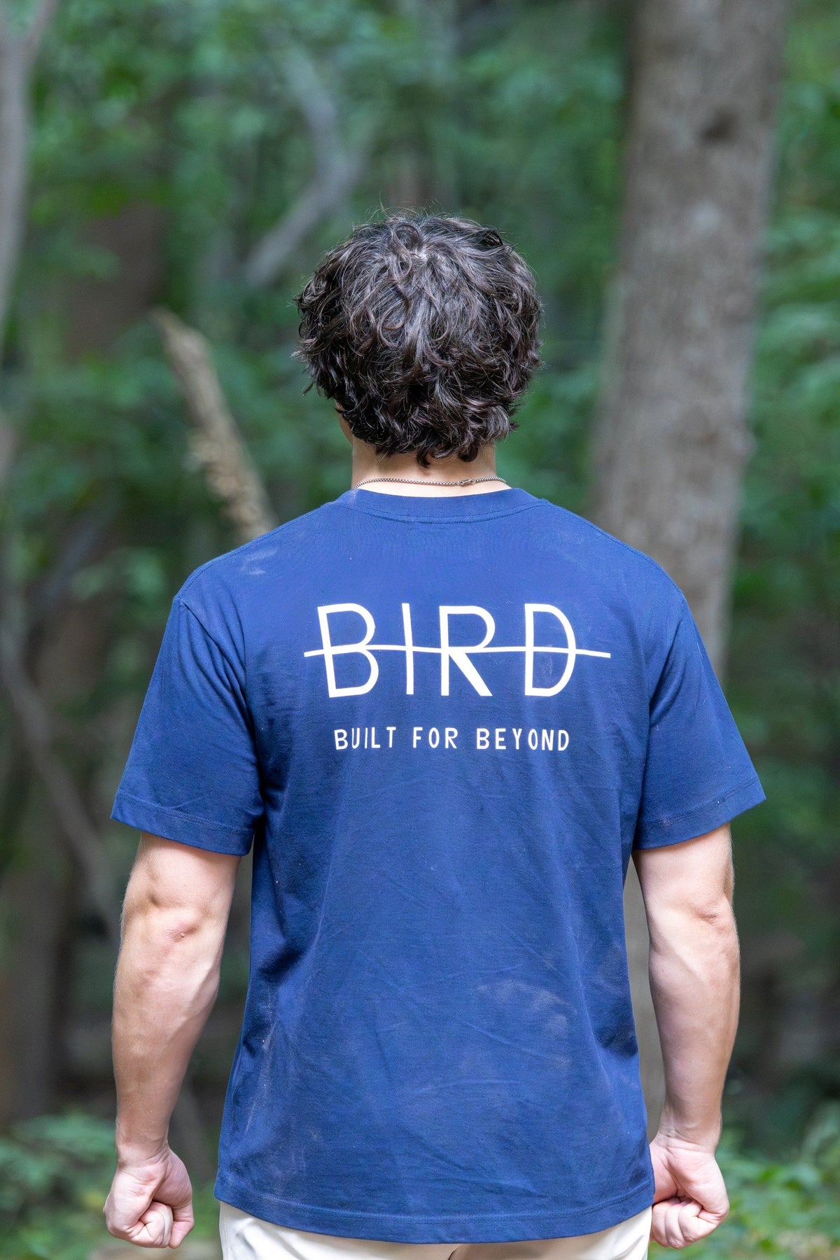 BIRD Falcon Tee in navy, worn outdoors