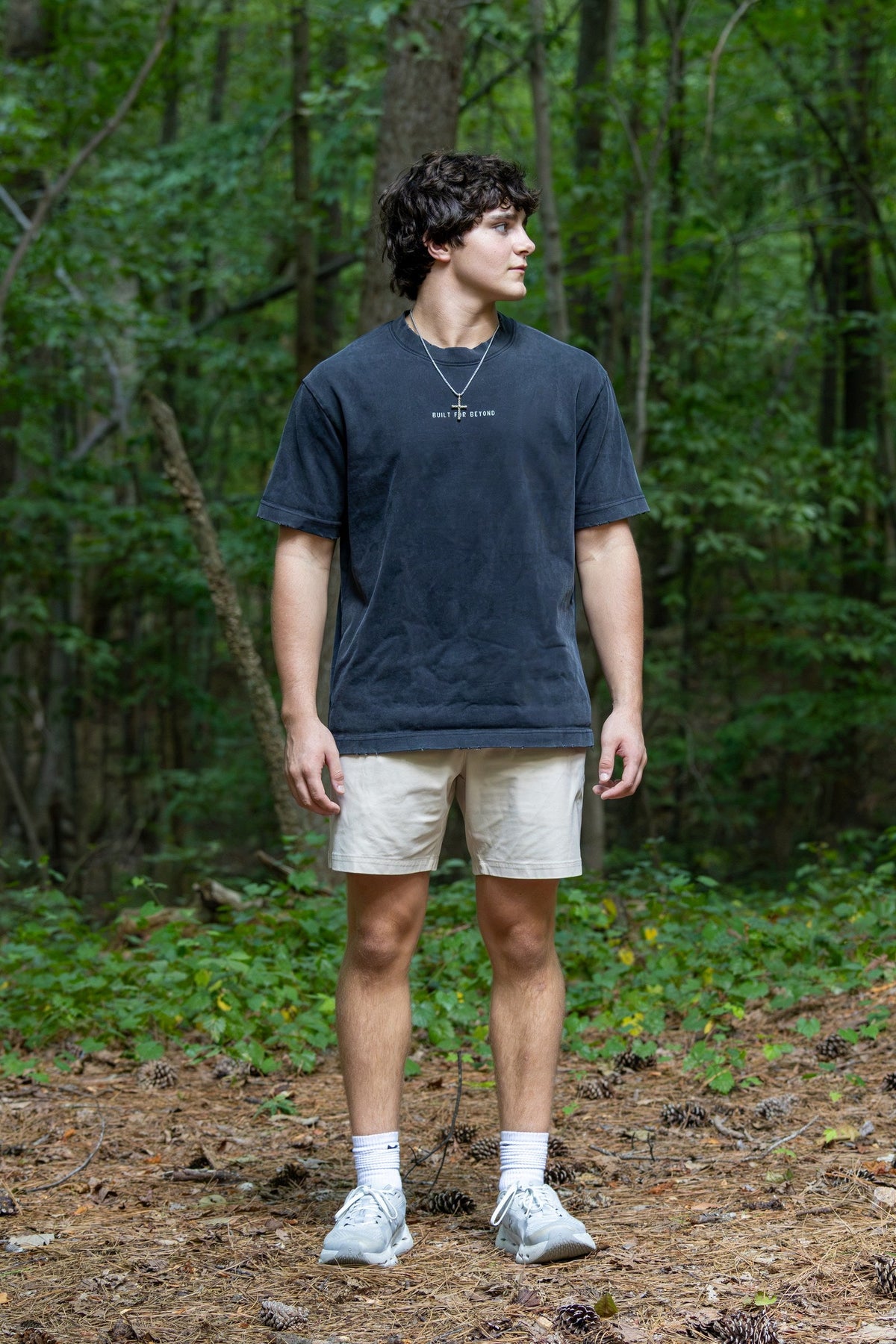 BIRD Go Further Tee, washed black, worn outdoors